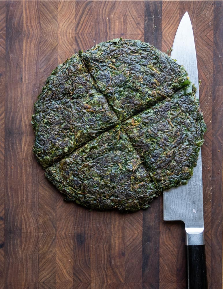 cutting a wild spinach or lambs quarters cake