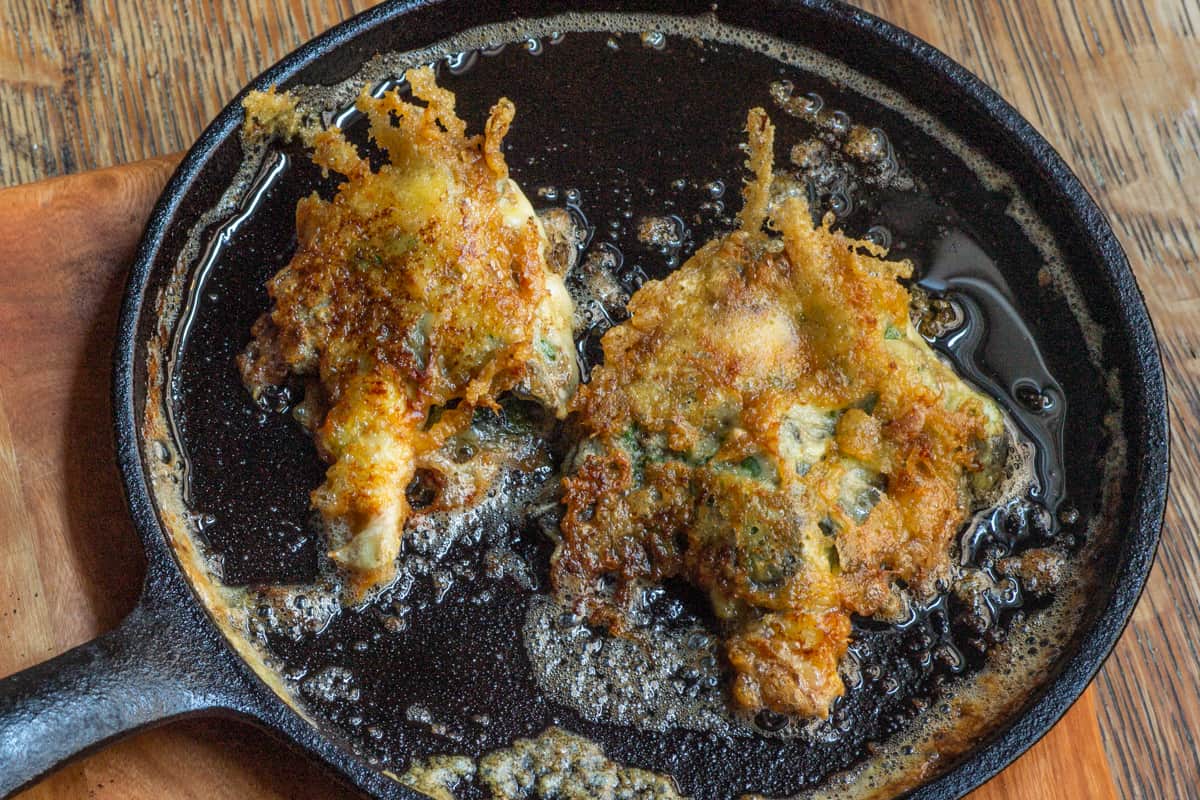 Parmesan crusted shaggy mane mushrooms cooking in a pan 