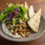 Mixed sauteed wild mushrooms with chipped cheese, flatbread and salad