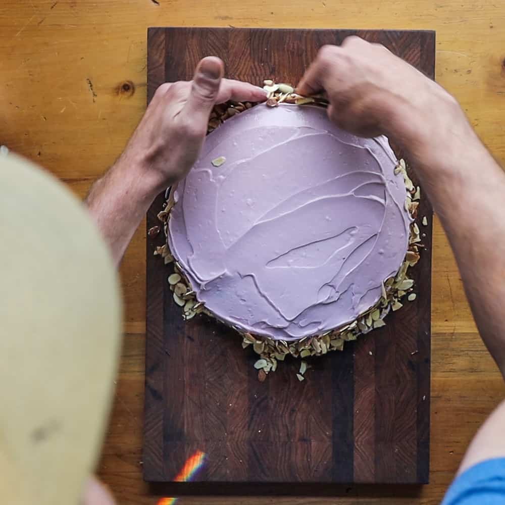 Cutting and frosting Russian Bird Cherry cake