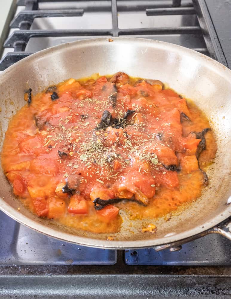 adding homemade tomato sauce to the pan