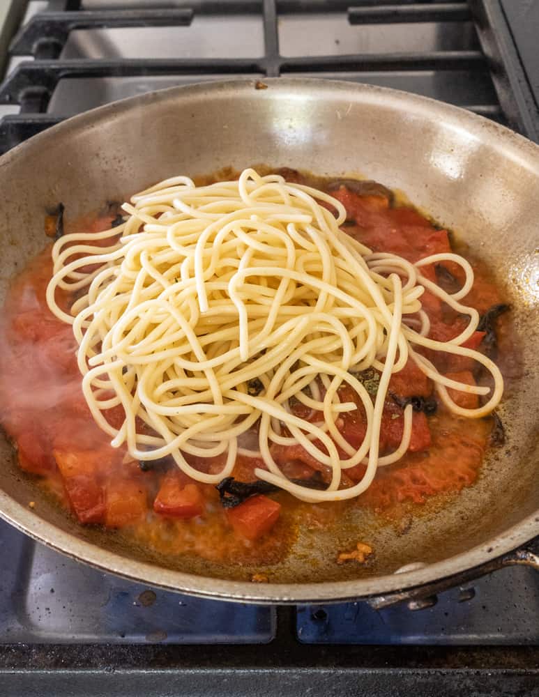 adding capellini pasta to the pan
