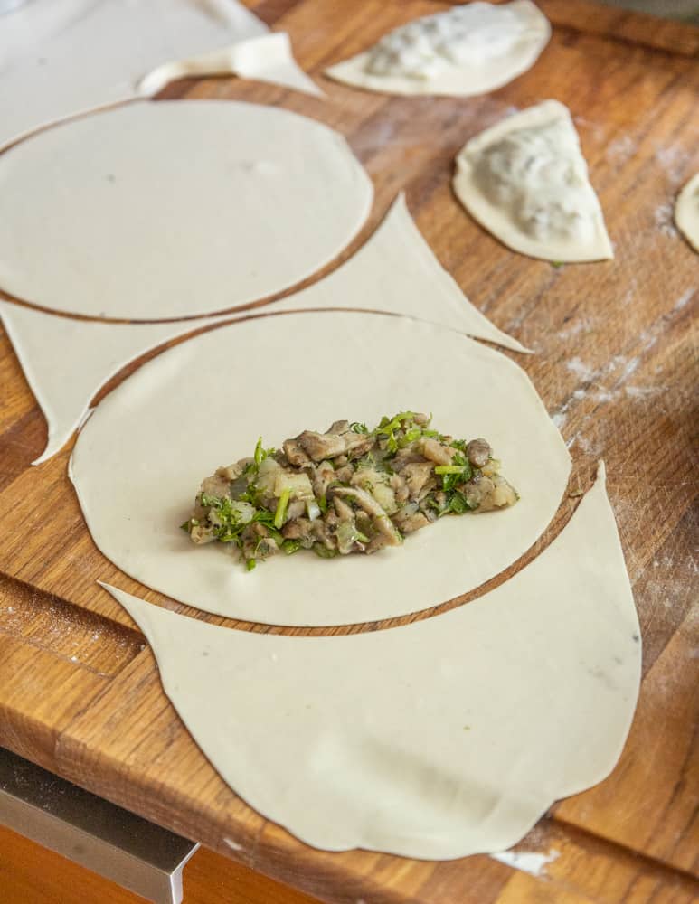 Filling chebureki with hen of the woods and honey mushroom filling