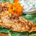 fried wild mushroom chebureki with seasoned sour cream on nasturtium leaves