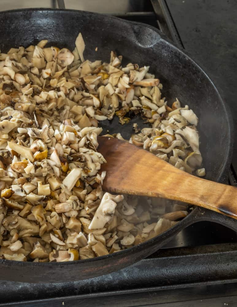 cooking finely chopped wild hen of the woods and honey mushrooms