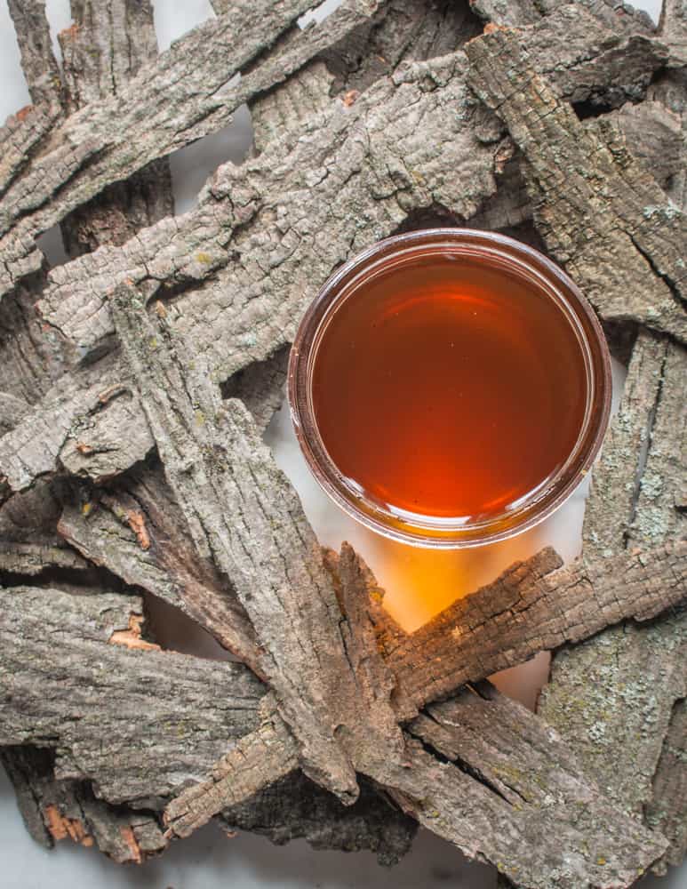 Hickory Bark Syrup surrounded by bark