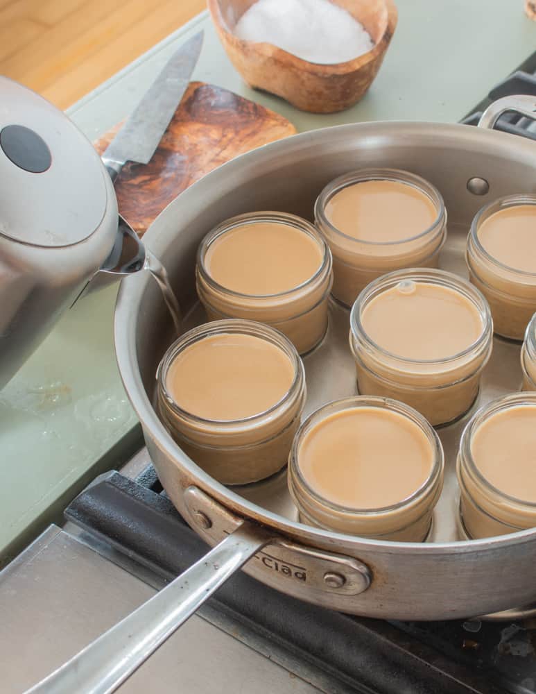 cooking shagbark hickory nut pot du creme in a water bath in jelly jars