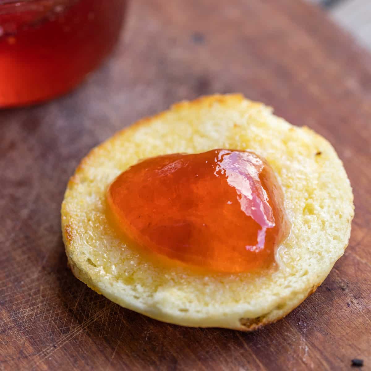 orange jelly on a buttered english muffin 