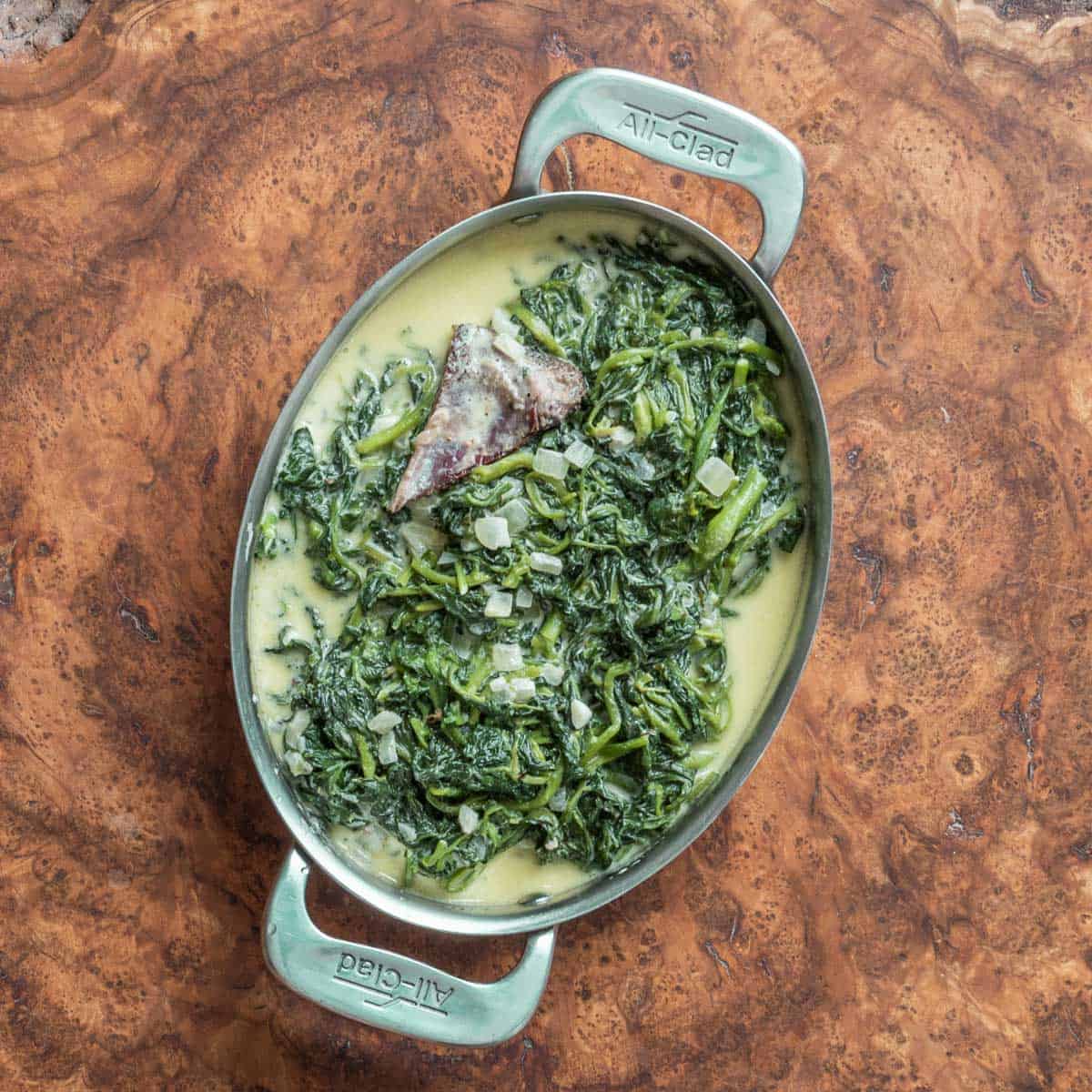 Creamed wild watercress in an all-clad pan