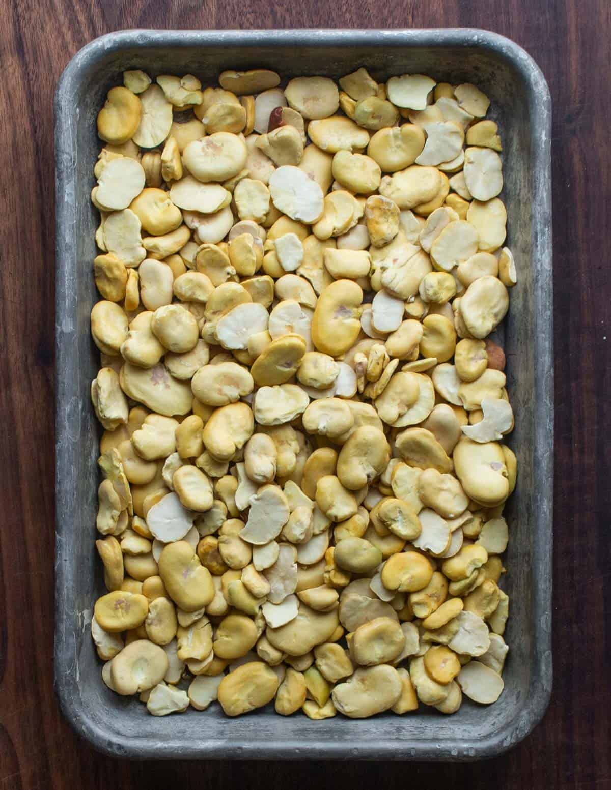 dried, peeled fava beans on a baking sheet 