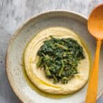 fava bean puree in a bowl with cooked greens