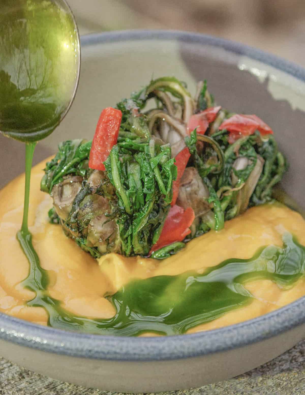 sweet potato puree with dandelion crowns in a bowl 