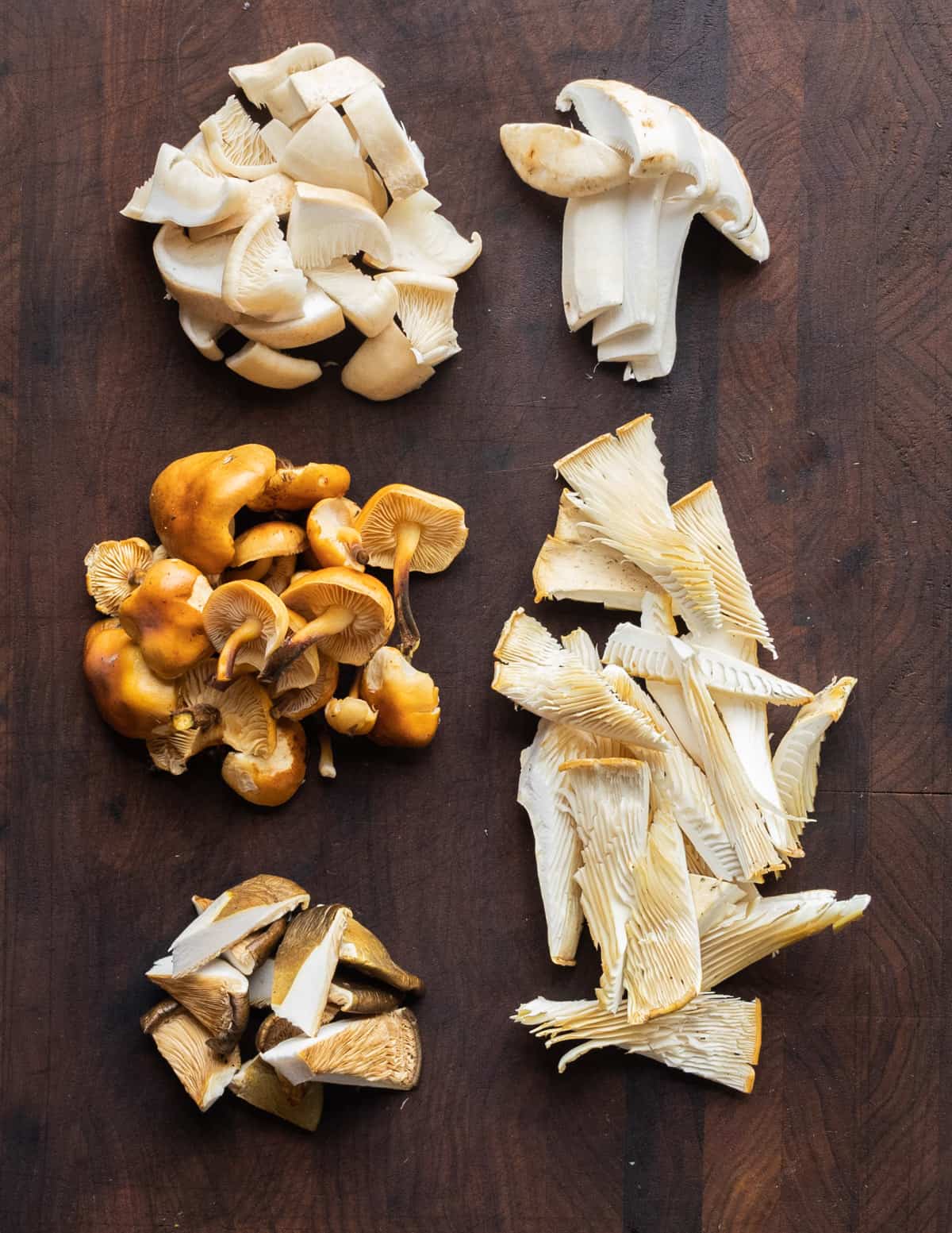 different wild mushrooms cut up for soup