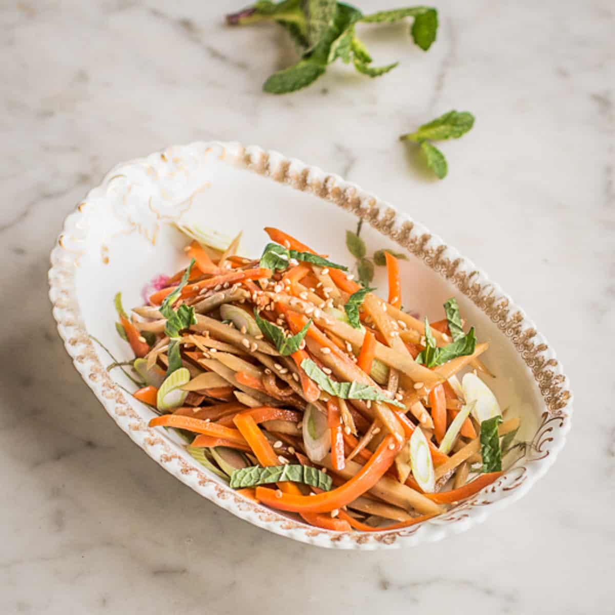 cooked carrot and gobo in a dish 