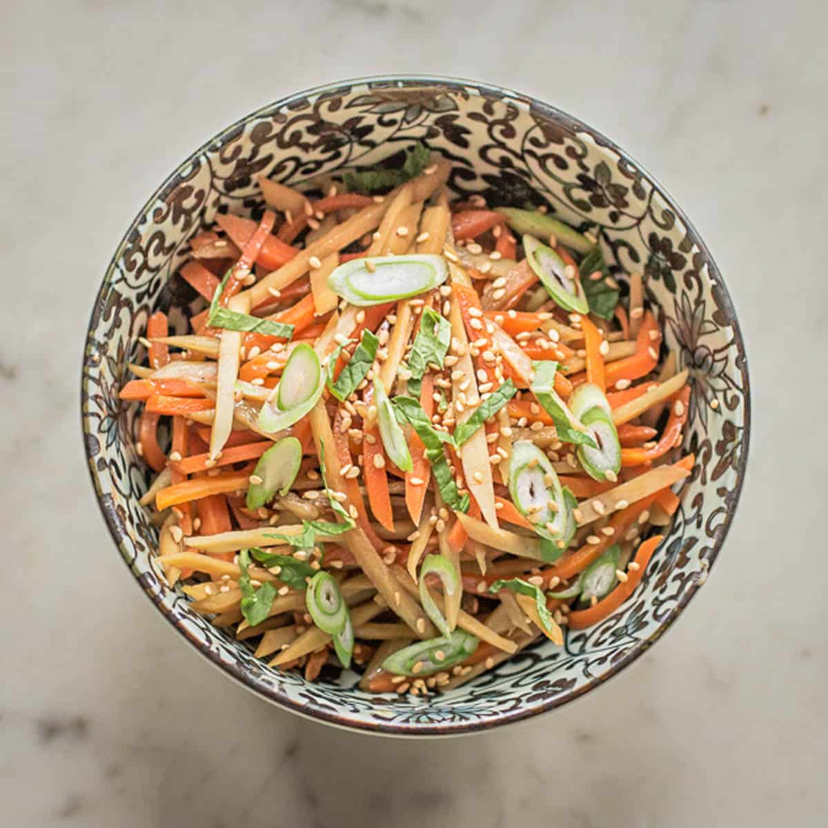 a bowl of cooked burdock and carrot roots 