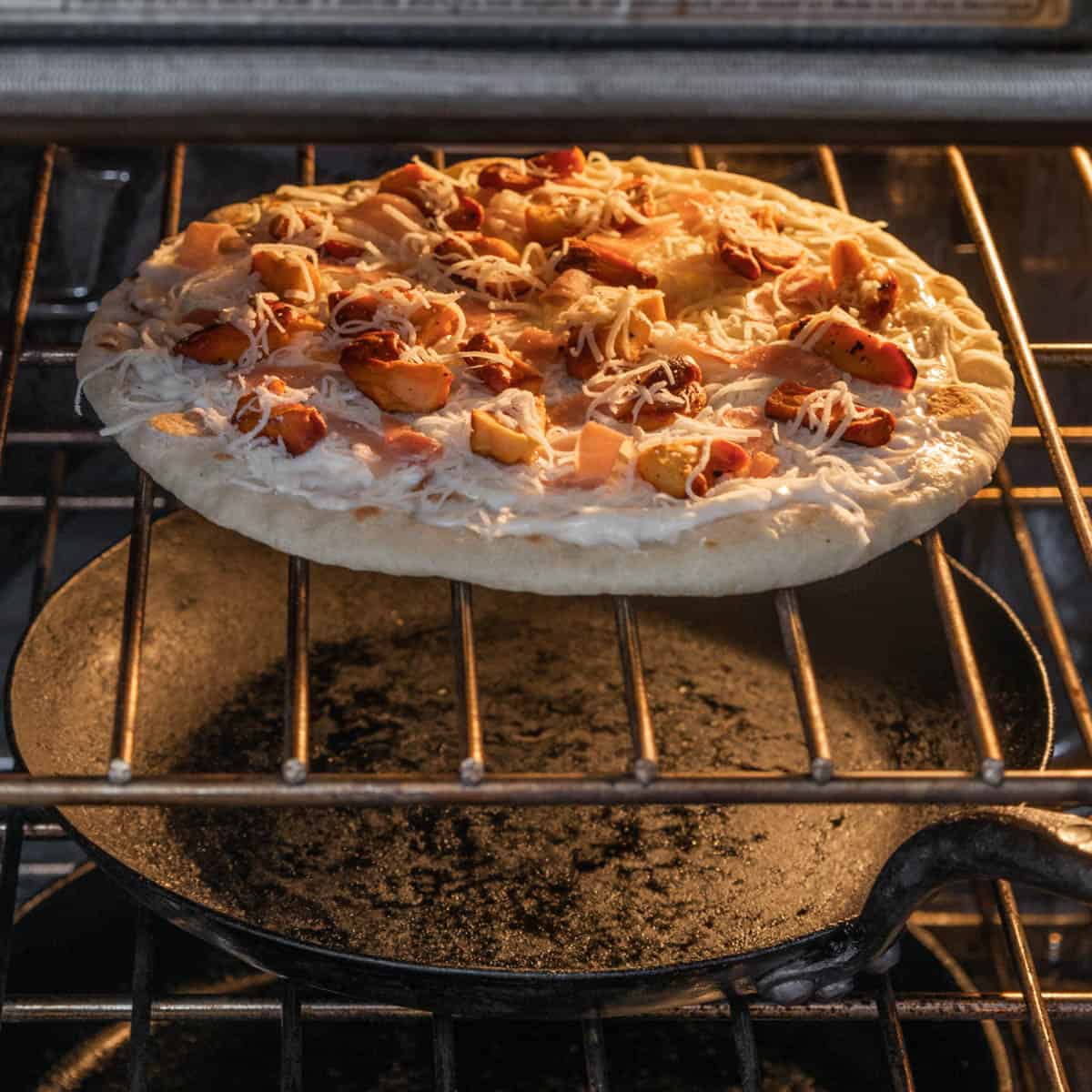 cooking a pizza in an oven on the rack
