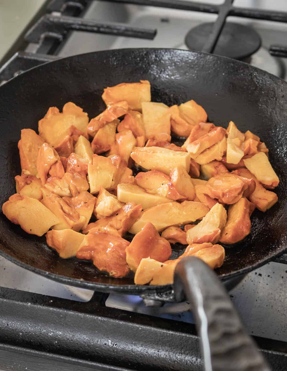 cooking orange mushrooms in a carbon pan