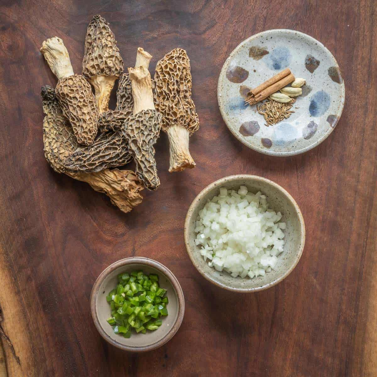 ingredients for mushroom pilau rice laid out on a board