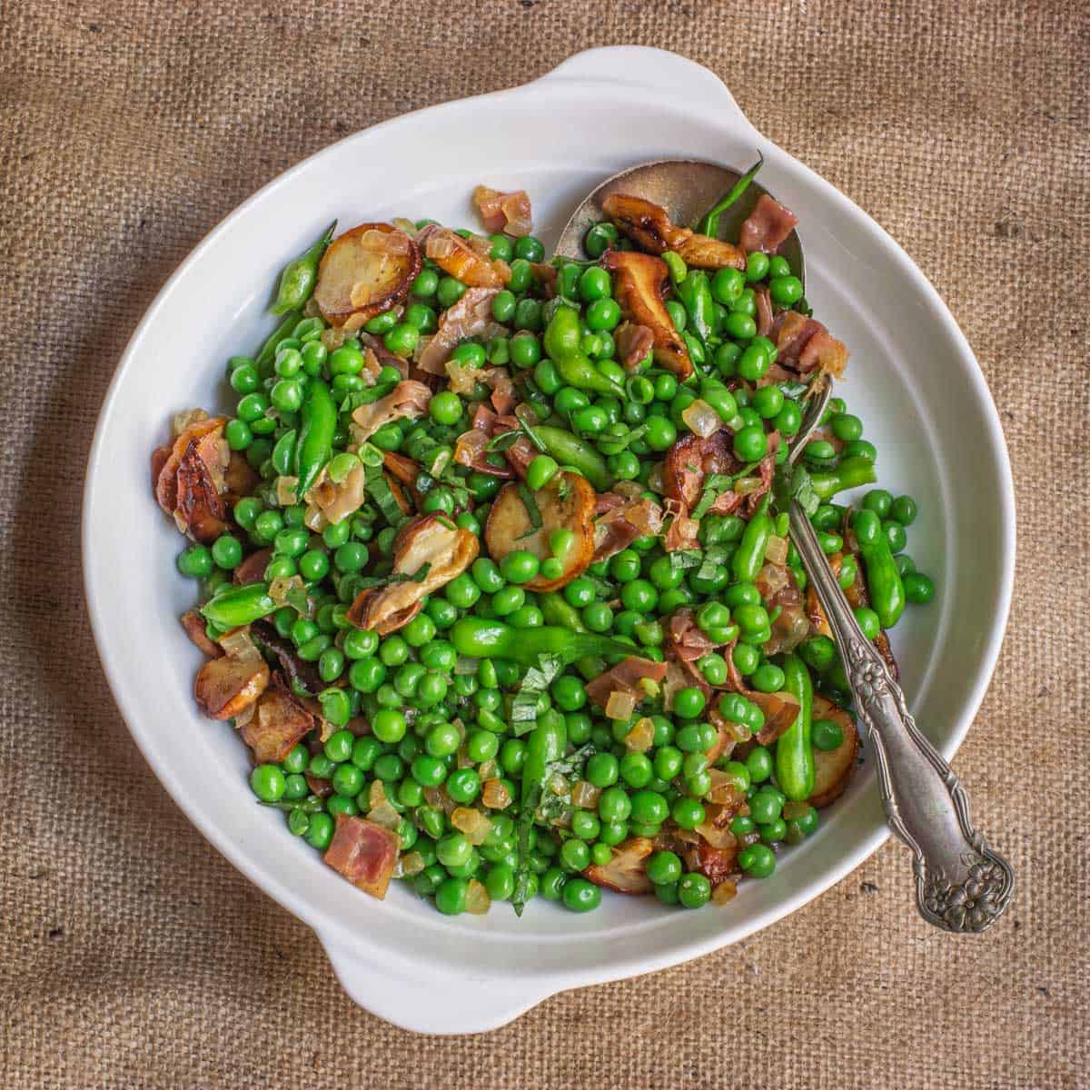 a bowl of peas and mushrooms with prosciutto 