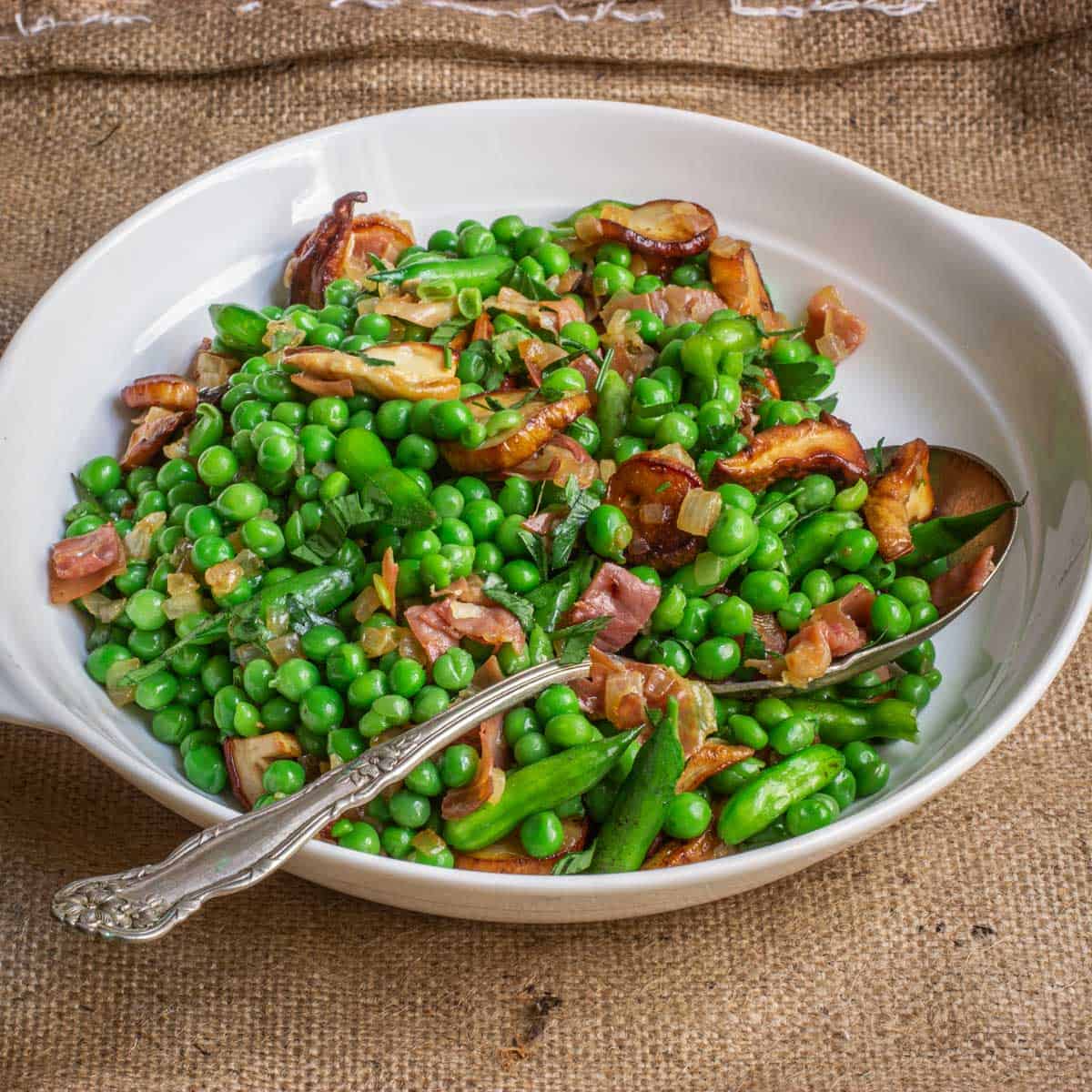 a bowl of peas and porcini mushrooms with prosciutto