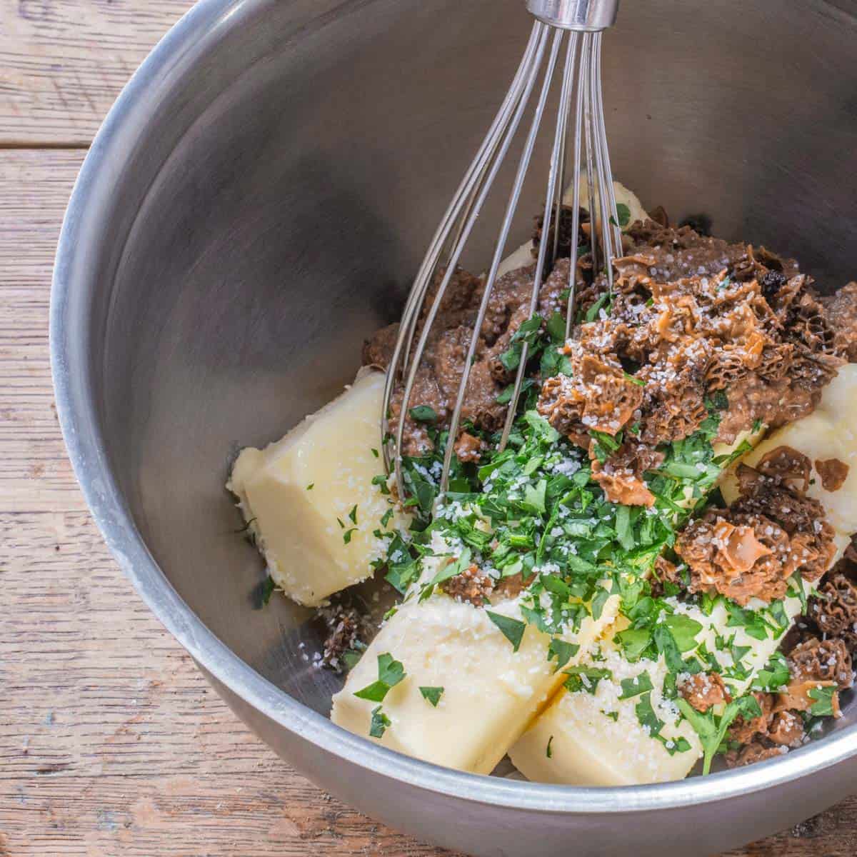 mixing mushroom butter with a whisk in a bowl