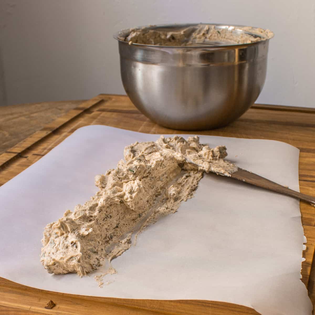 spreading out mushroom butter on parchment