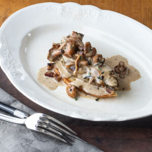 Veal liver on toast with mushrooms, bacon and onions