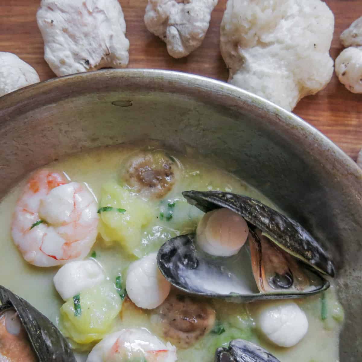 seafood ragu with mushrooms cooking in a pan