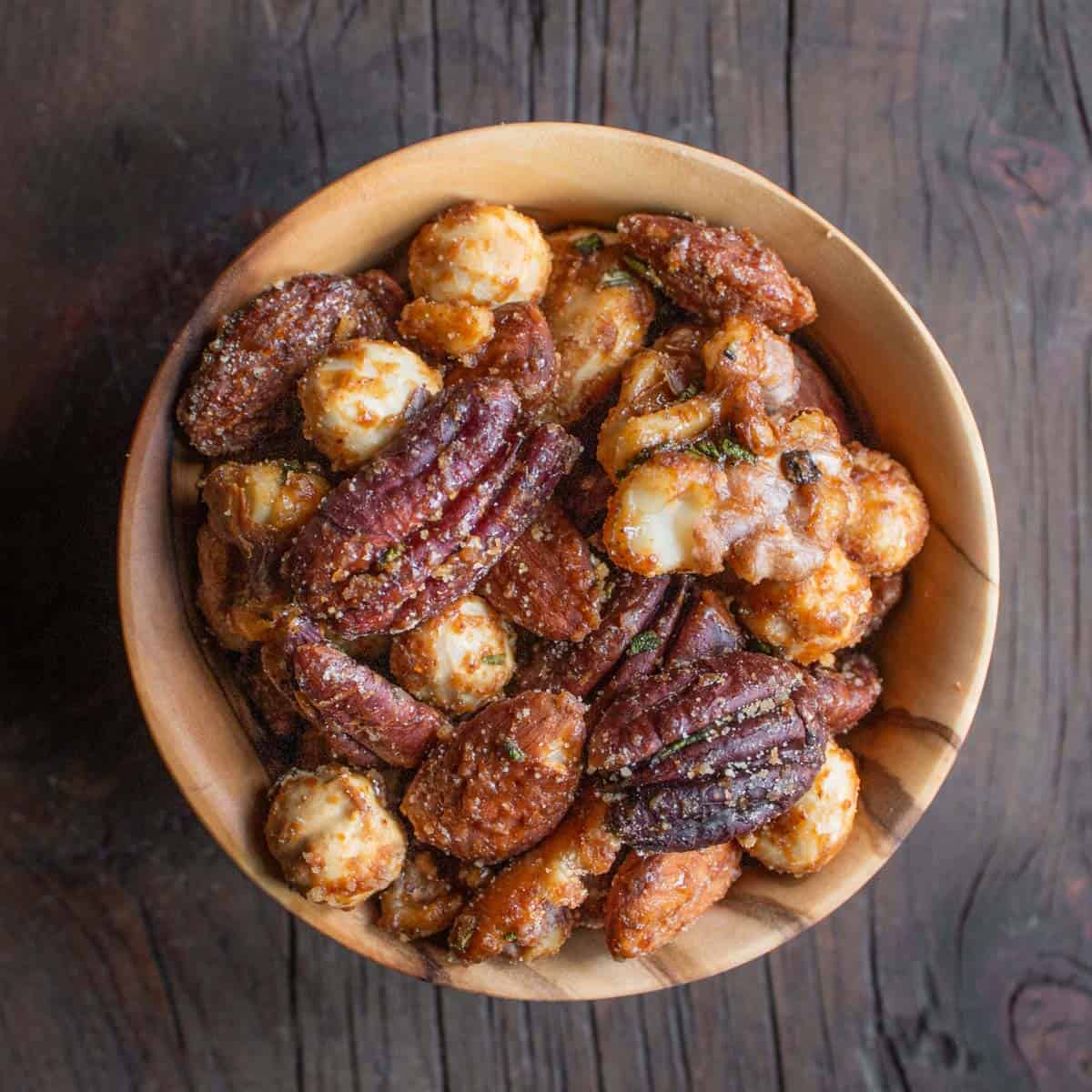 a bowl of candied walnuts, pecans, hazelnuts and almonds