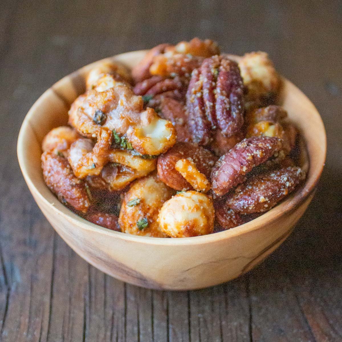 a bowl of candied walnuts, pecans, hazelnuts and almonds