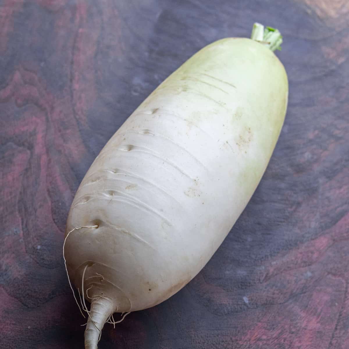 a daikon radish on a cutting board