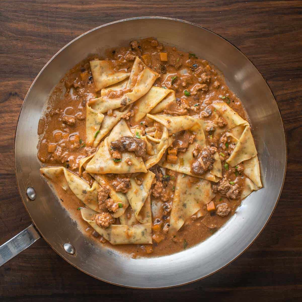 a pan of fresh pasta with wild boar sauce
