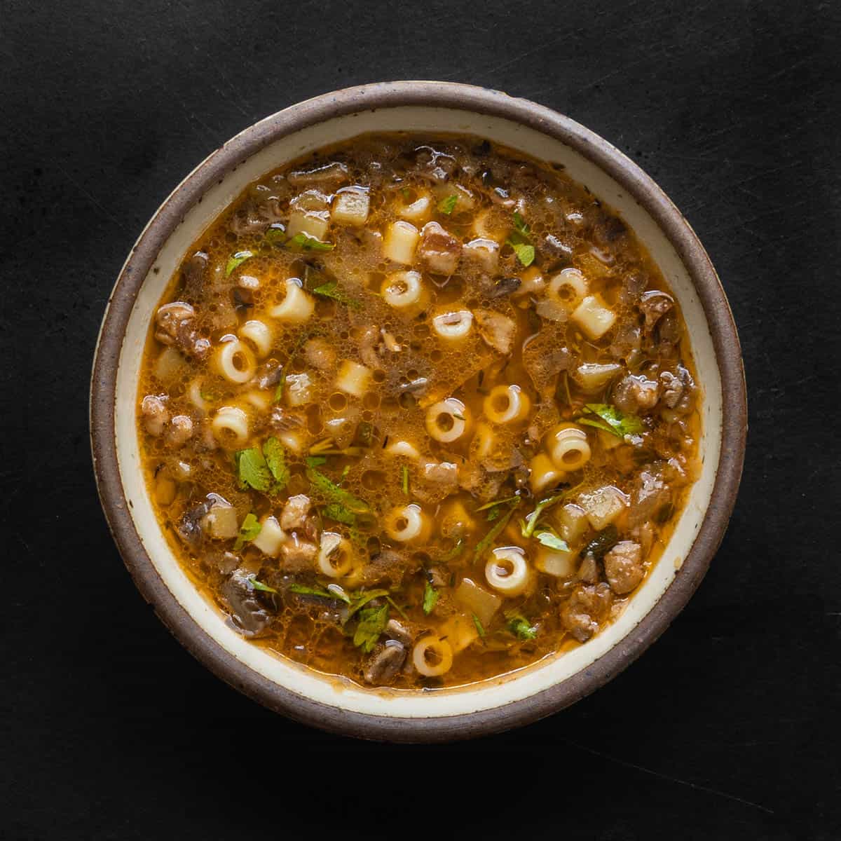 A bowl of mushroom soup with pasta