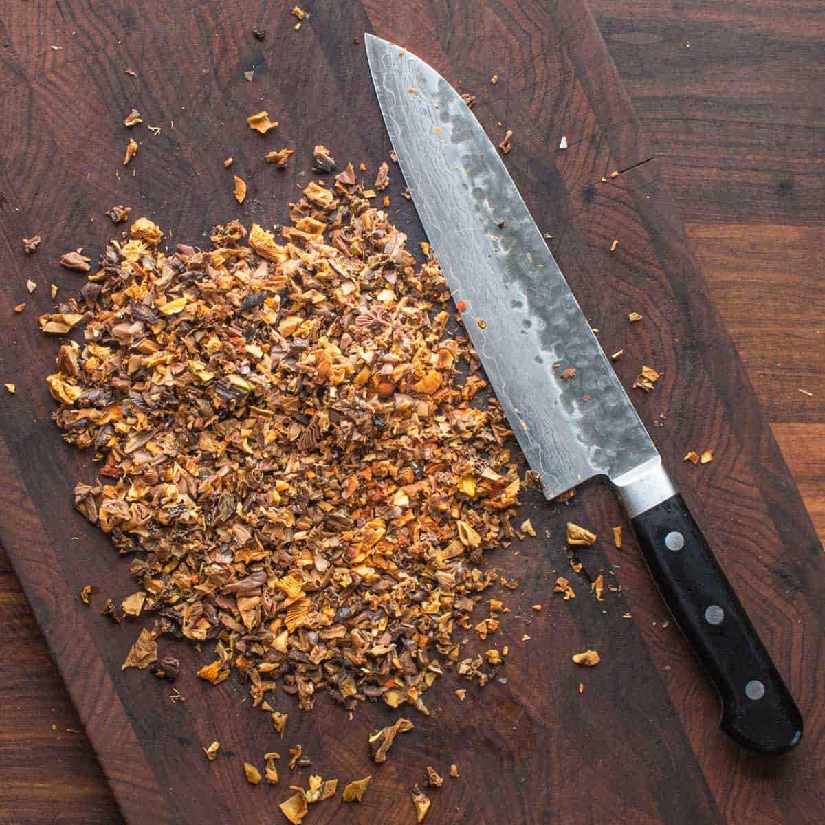 chopping dried mushrooms on a cutting board
