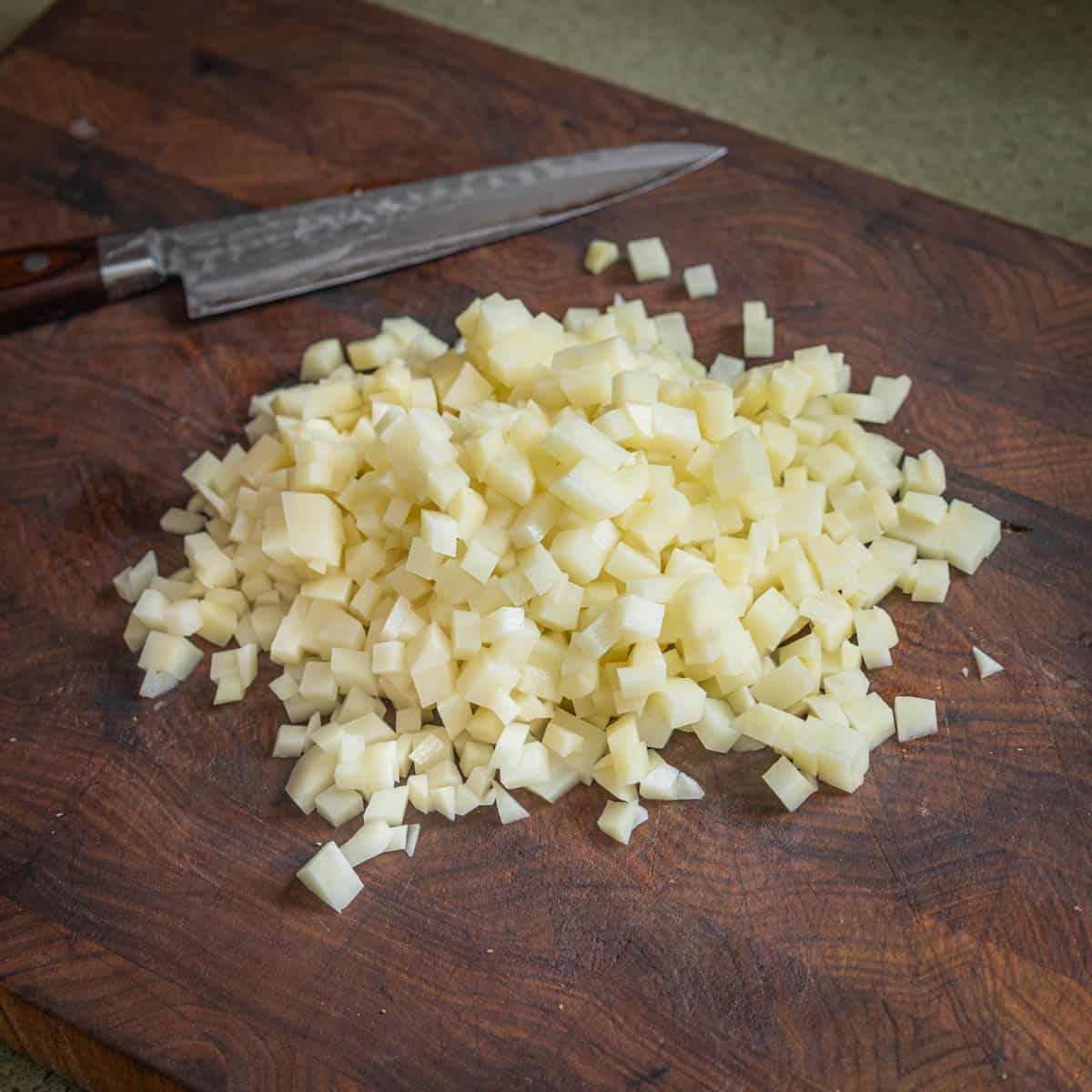 brunoise diced potatoes on a cutting board