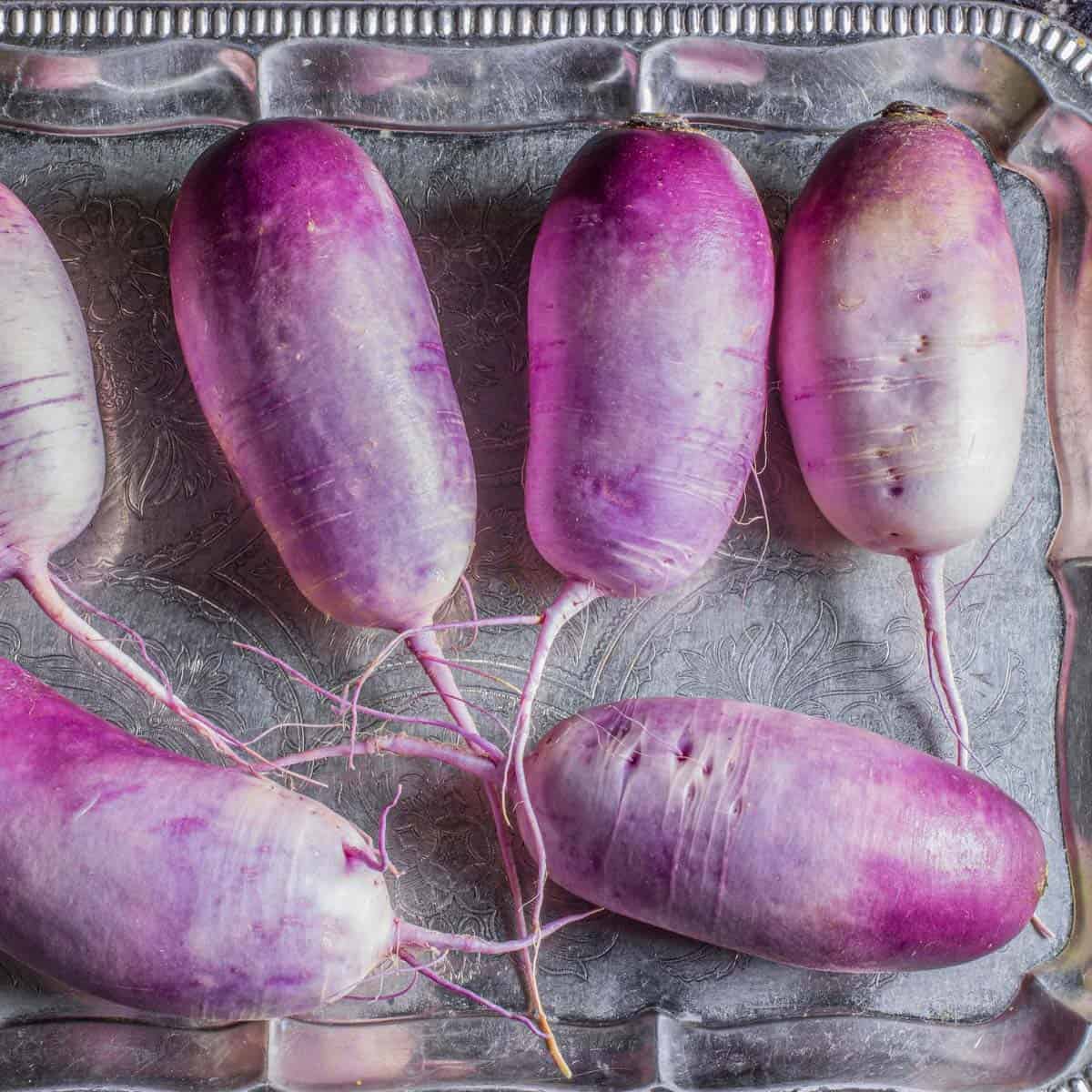 purple radishes on a tray