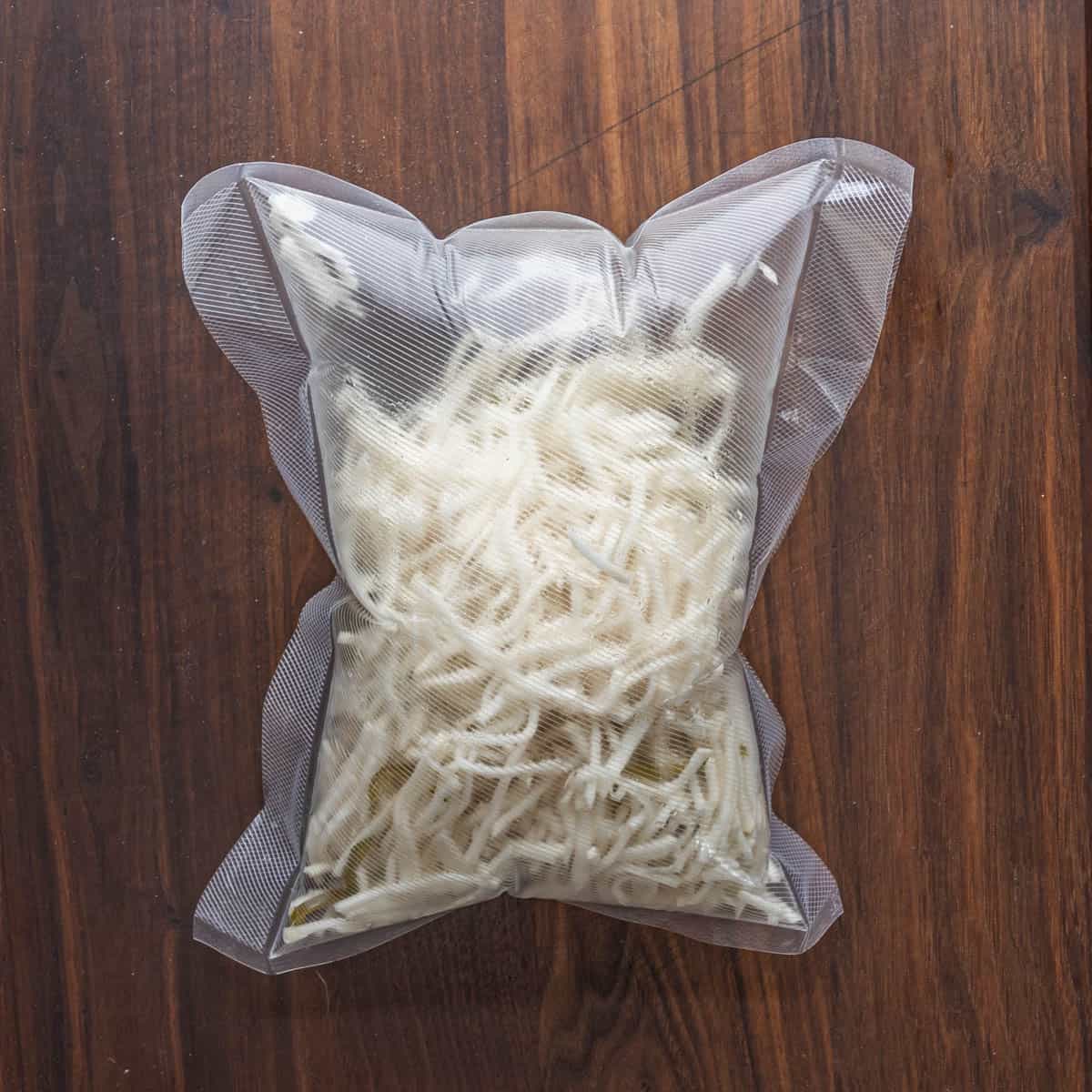 a vacuum bag filled with sliced turnips that's inflated.