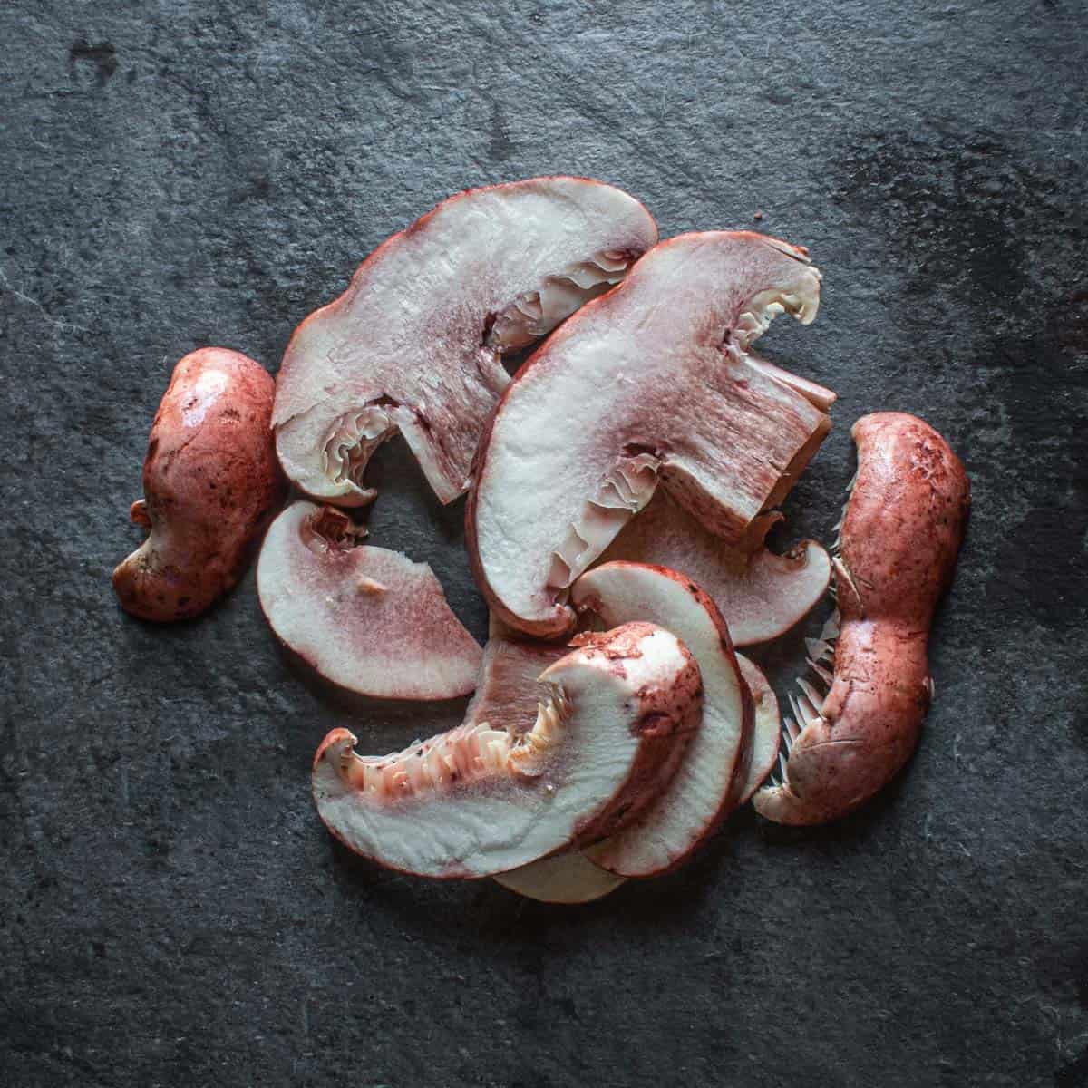 Sliced pink mushrooms on a piece of slate 