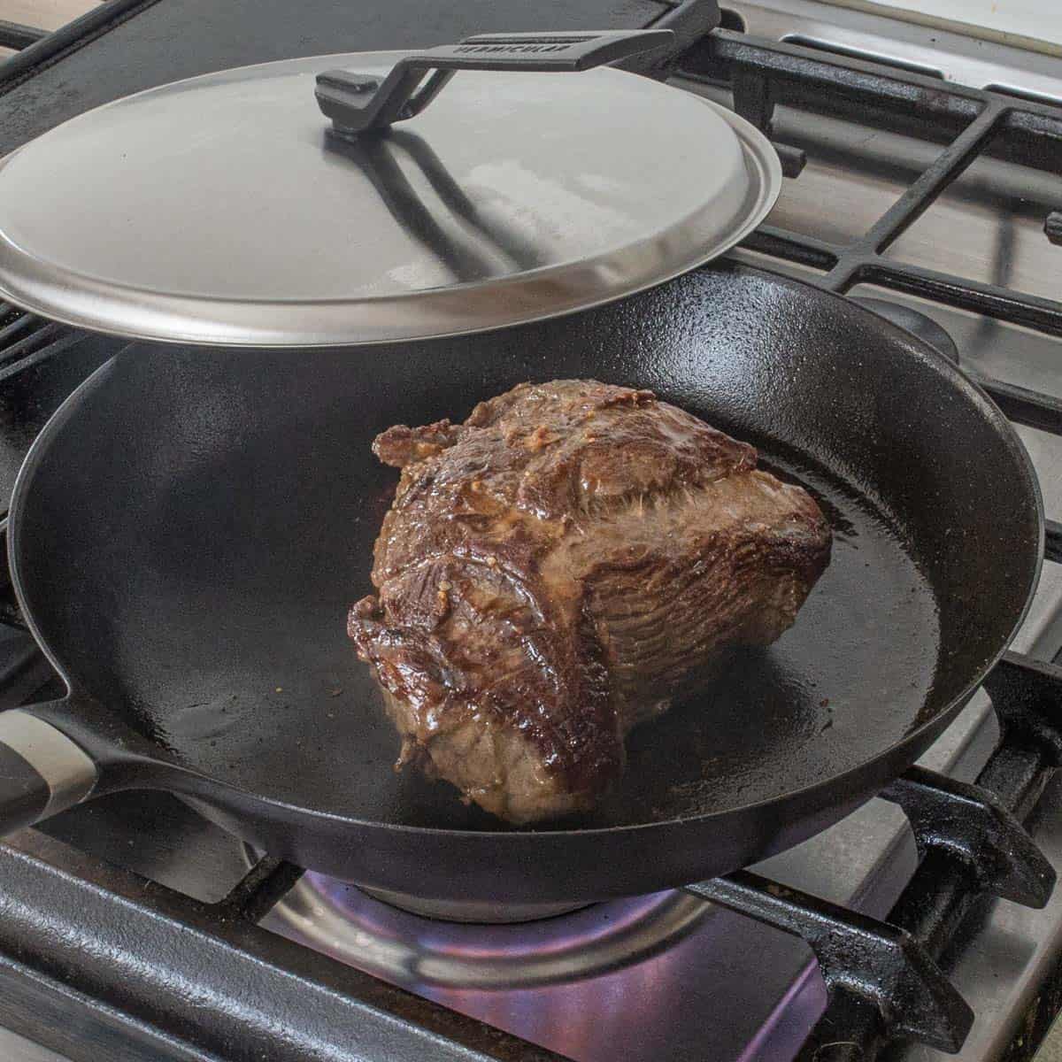 Browning a piece of venison in a pan