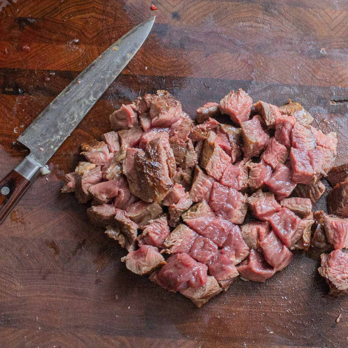 Cutting up browned venison 