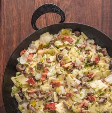 Pasta, cabbage, mushrooms and bacon in a carbon steel pan