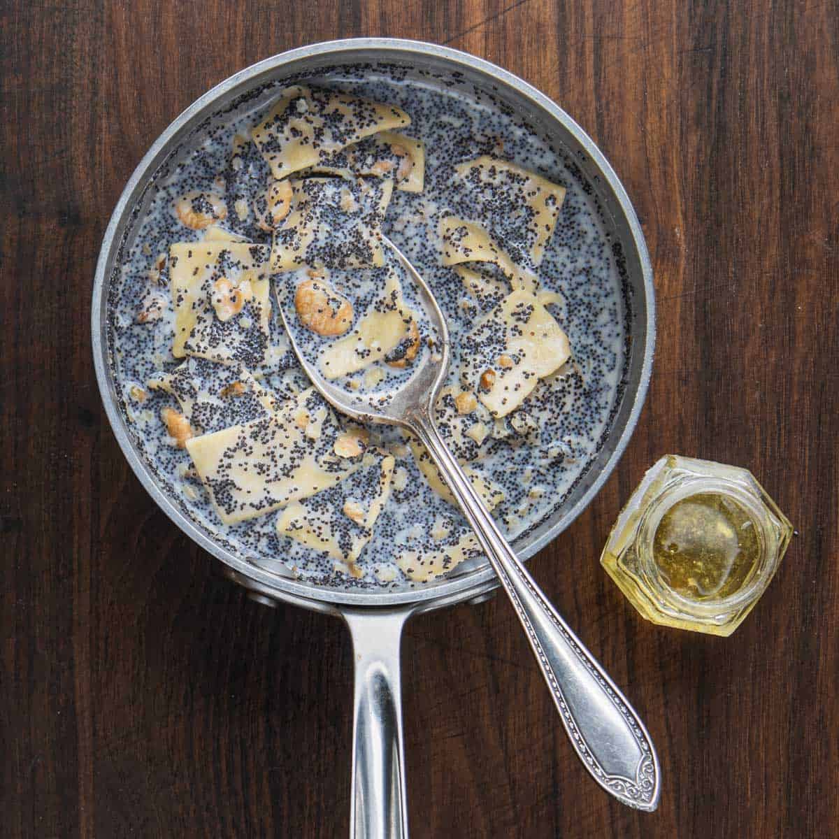 a pan of pasta with poppyseed sauce, nuts and honey