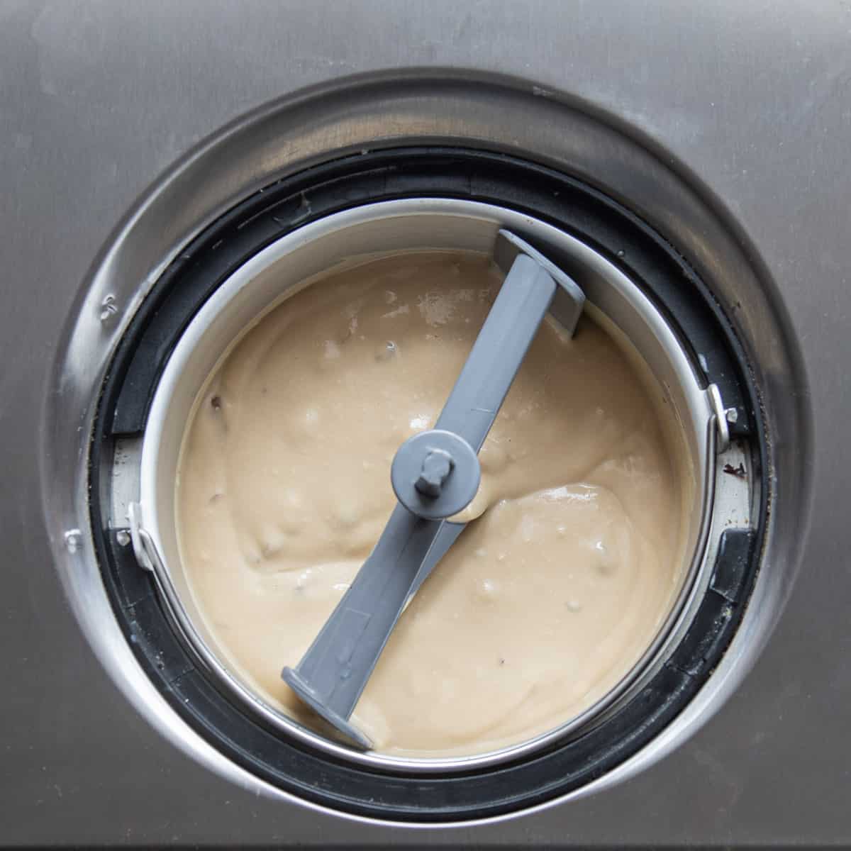 churning black walnut ice cream in an ice cream maker.