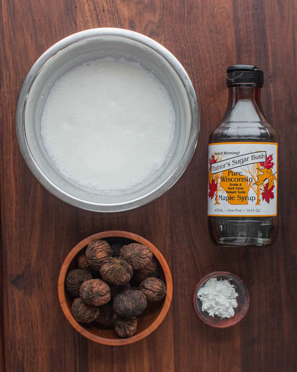 Black walnut ice cream ingredients on a cutting board.