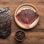 Sliced elk bresaola on a plate.