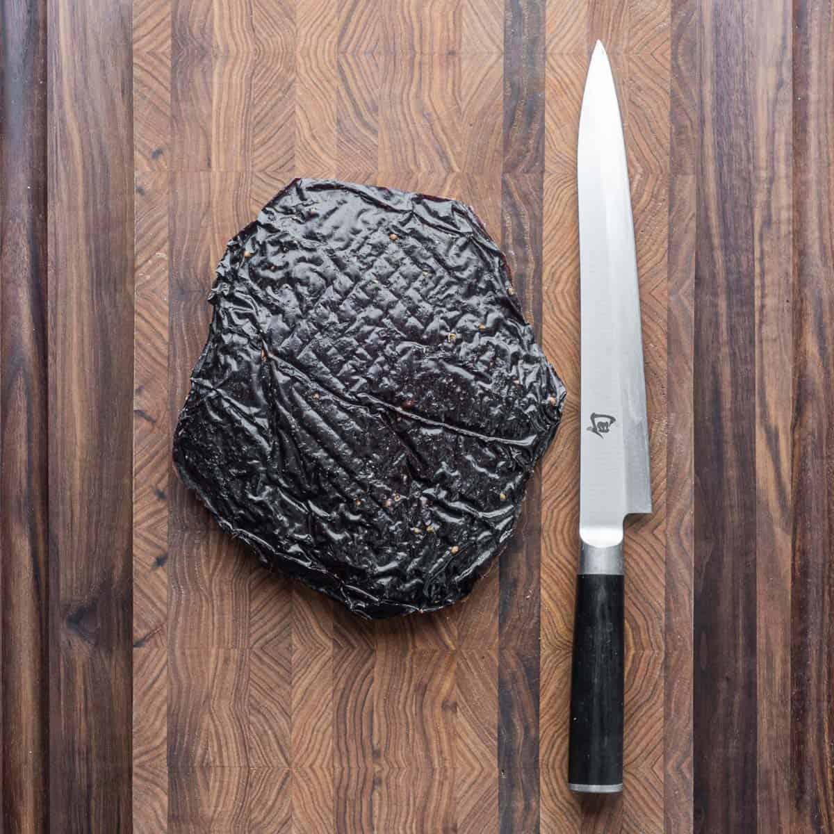 Elk bresaola on a cutting board. 