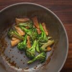 A top down image showing abalone mushrooms cooking in broccoli mushroom stir fry.