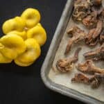 A tray of baked oyster mushrooms next to fresh golden oyster mushrooms.