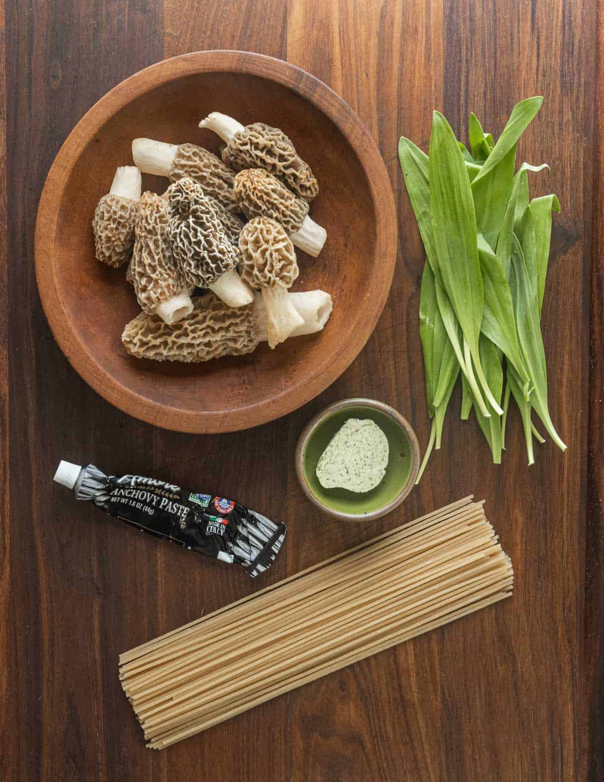 Morel pasta ingredients: ramp leaves, ramp butter, dried spaghetti, and morel mushrooms. 