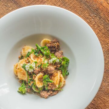 a bowl of orecchiette pasta with sausage, broccoli rabe, and breadcrumbs.